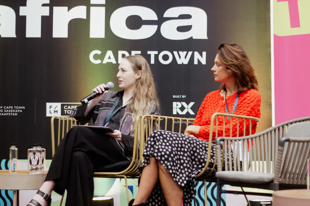 An image of Astrid talking at a panel. She is a woman in the music industry.